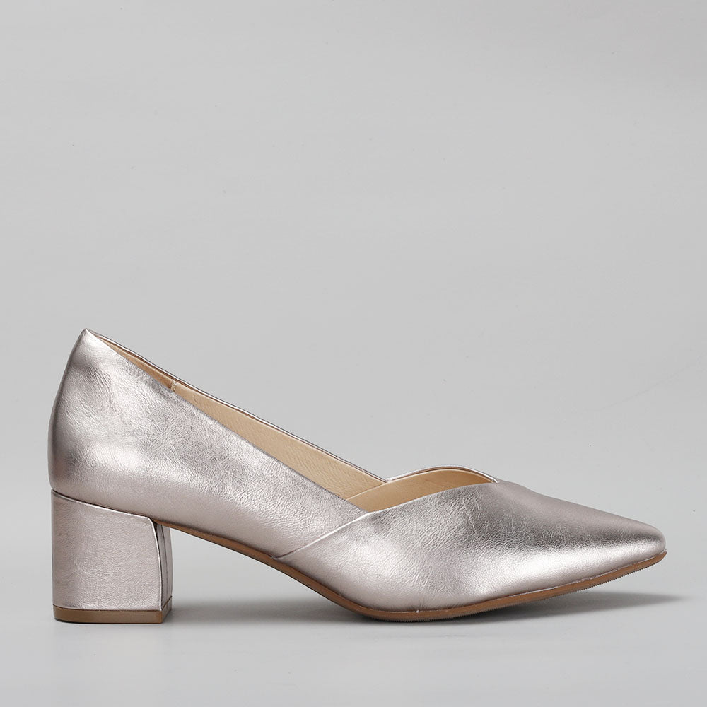 Le Sansa Carly Champagne heels with sleek side view, featuring a pointed toe and elegant ankle strap in champagne color.
