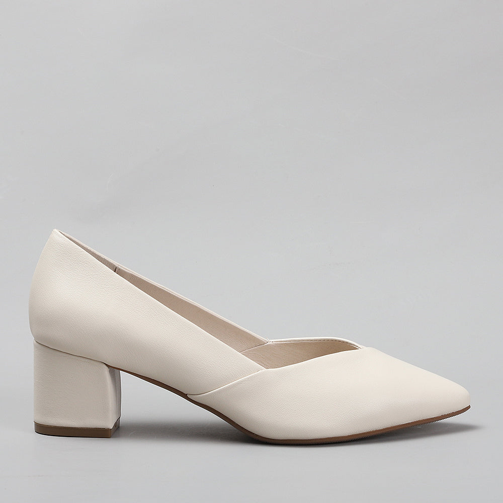 Le Sansa Carly Nude heels shown from the side, featuring a sleek design and nude color perfect for elegant footwear.
