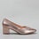 Le Sansa Carly Rose Gold heels shown from the side, featuring elegant design and metallic rose gold finish.
