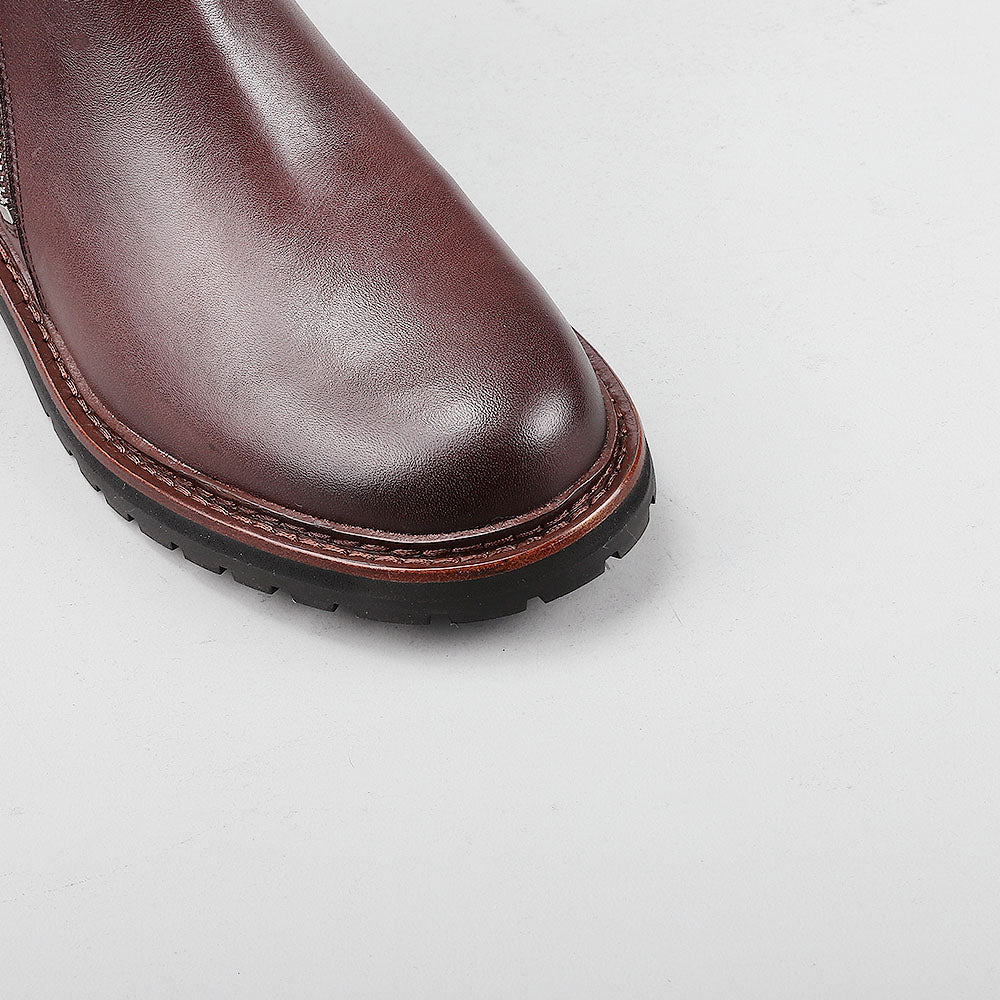 Close-up of Le Sansa Cayla chocolate boots showing the detailed leather texture and stylish design.