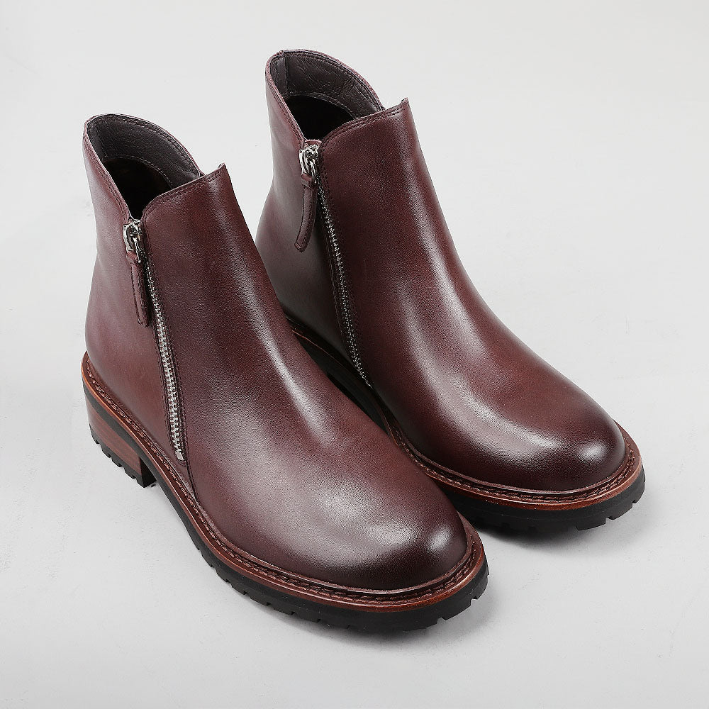 Pair of Le Sansa Cayla chocolate boots showing their stylish design and brown leather material.