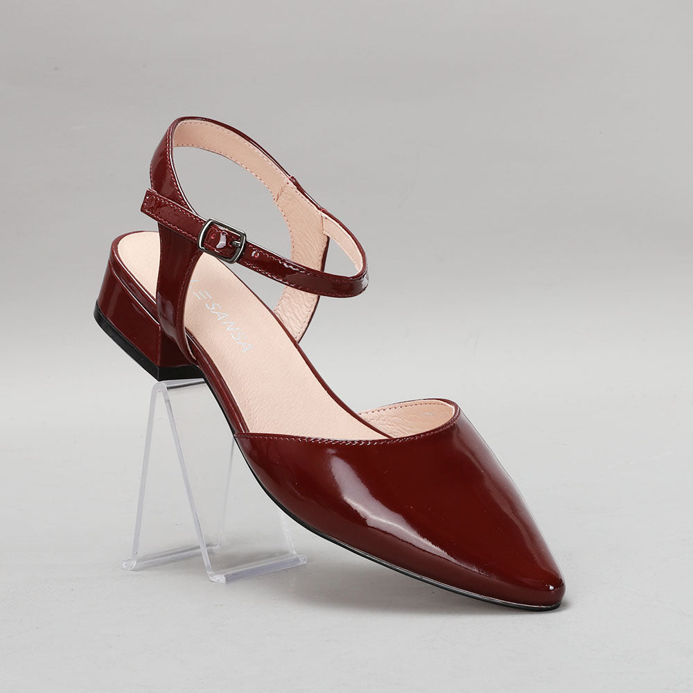 Le Sansa Coralie Merlot Patent sandals with glossy red finish and open toe design, featuring ankle straps and sturdy heel.