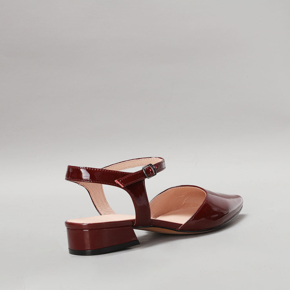 Le Sansa Coralie Merlot patent sandals with ankle straps and open toe design, showcasing sleek, shiny red finish.