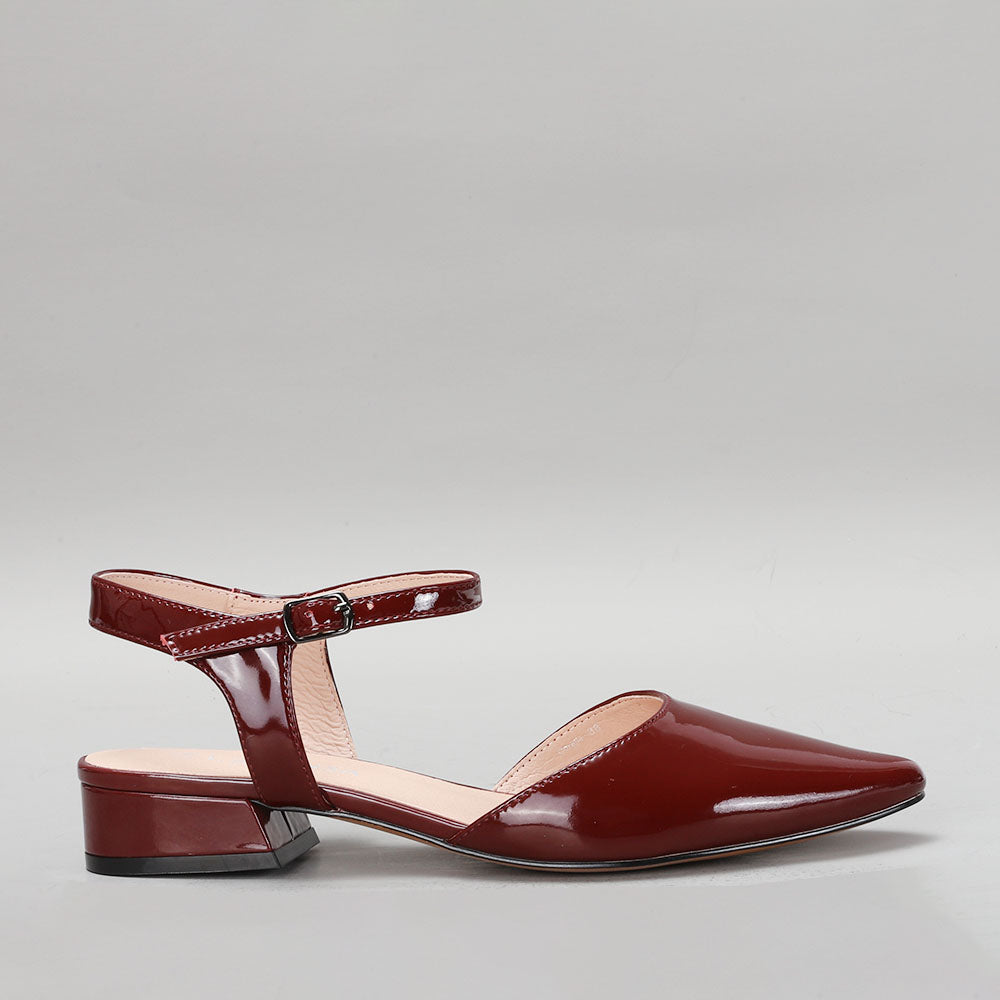 Le Sansa Coralie Merlot patent sandals shown from the side, featuring sleek design and glossy merlot-colored patent leather.