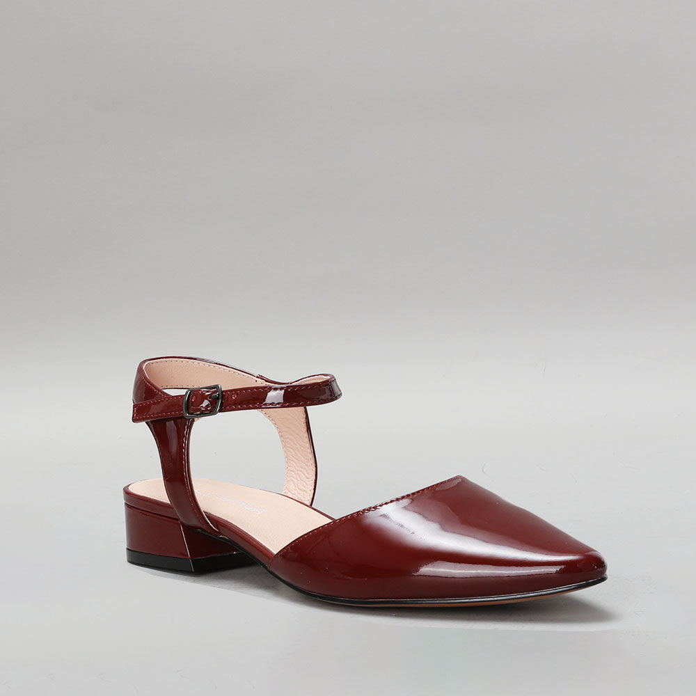 Le Sansa Coralie Merlot Patent sandals with sleek straps and glossy finish, displayed on a neutral background.