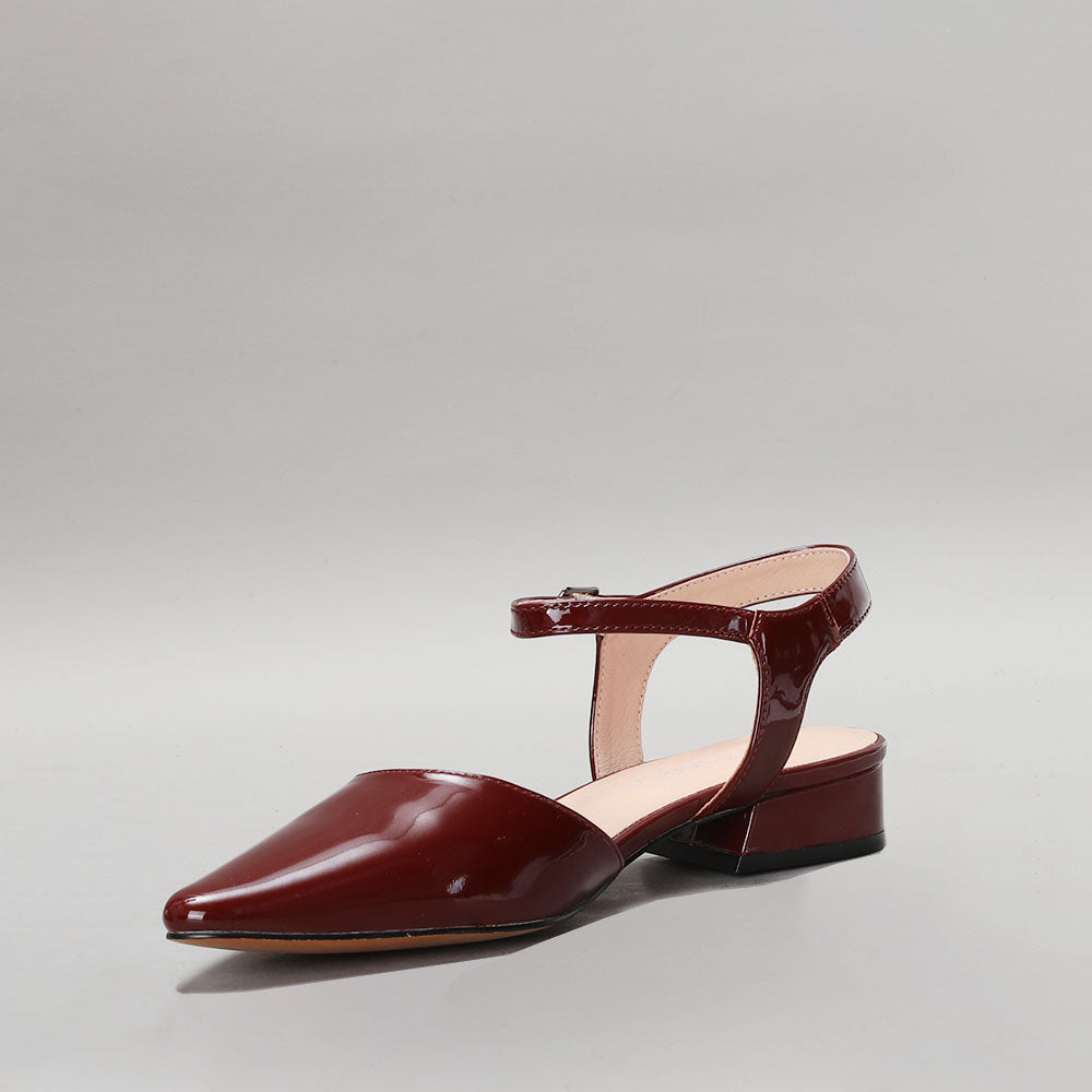 Le Sansa Coralie Merlot Patent sandals with sleek, shiny red patent leather straps and open toe design.