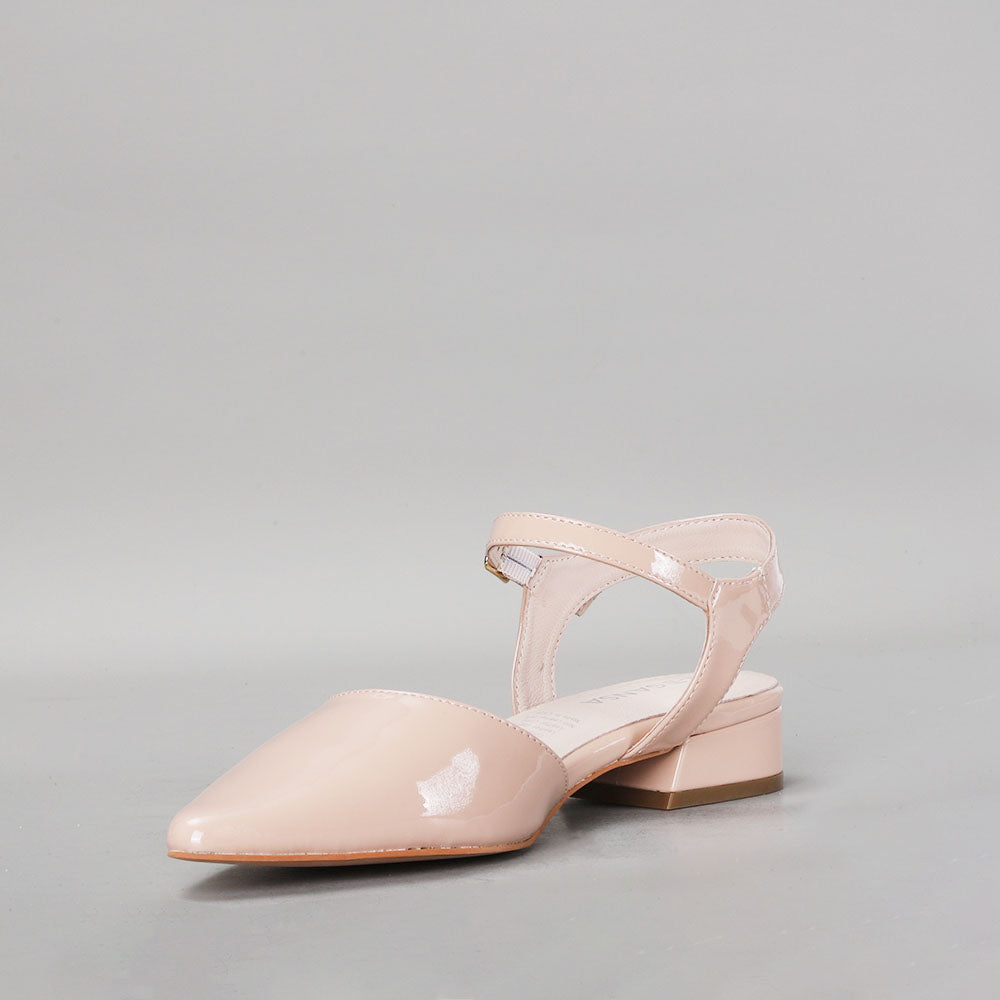 Le Sansa Coralie Nude Patent Sandals featuring sleek straps and a glossy finish on a neutral-colored footwear display.