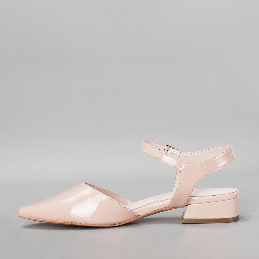 Le Sansa Coralie Nude Patent Sandals with sleek straps and low heel, displayed on a neutral background.