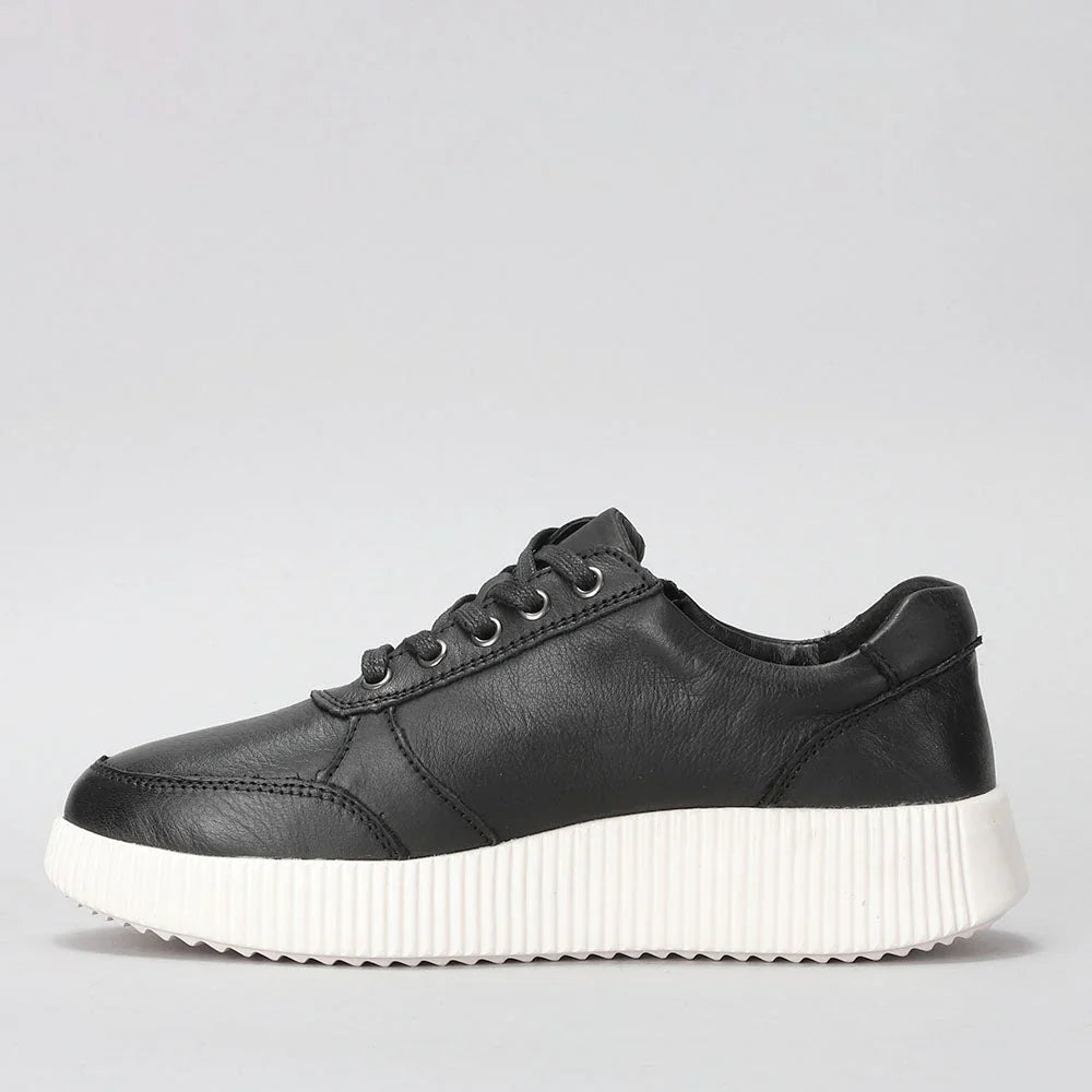 Black Le Sansa Cosco sneakers with white sole and sleek design, displayed on a neutral background.