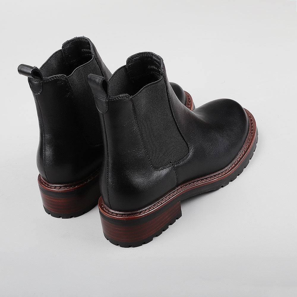 Black leather boots from Le Sansa, featuring a sleek design and ankle-height silhouette, shown from the back.