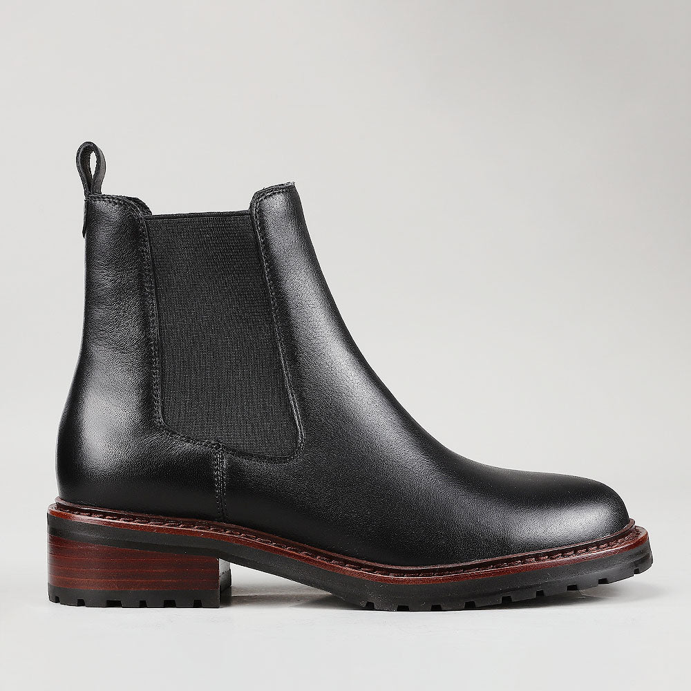 Le Sansa Costa Black boots shown from side, featuring sleek black leather design and stylish ankle height.