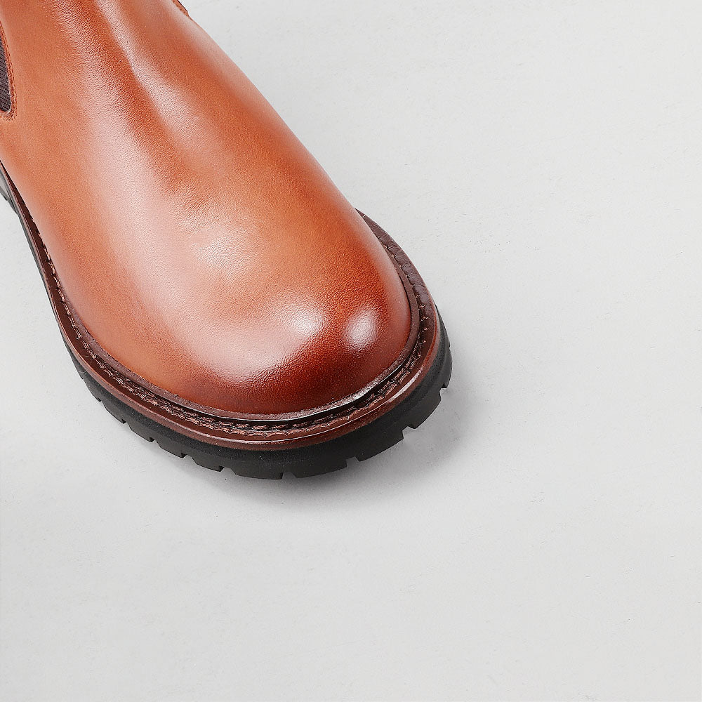 Close-up of Le Sansa Costa Brandy boots showing detailed leather texture and stylish design.
