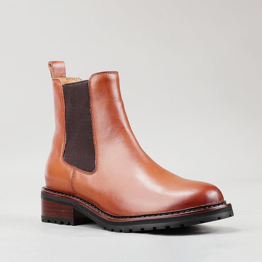 Le Sansa Costa brandy boots with tan leather and decorative stitching, featuring a rounded toe and sturdy sole.