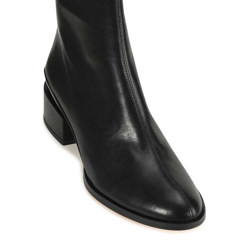 Eos Cast Black boots shown from a top view, featuring sleek black leather and stylish design.