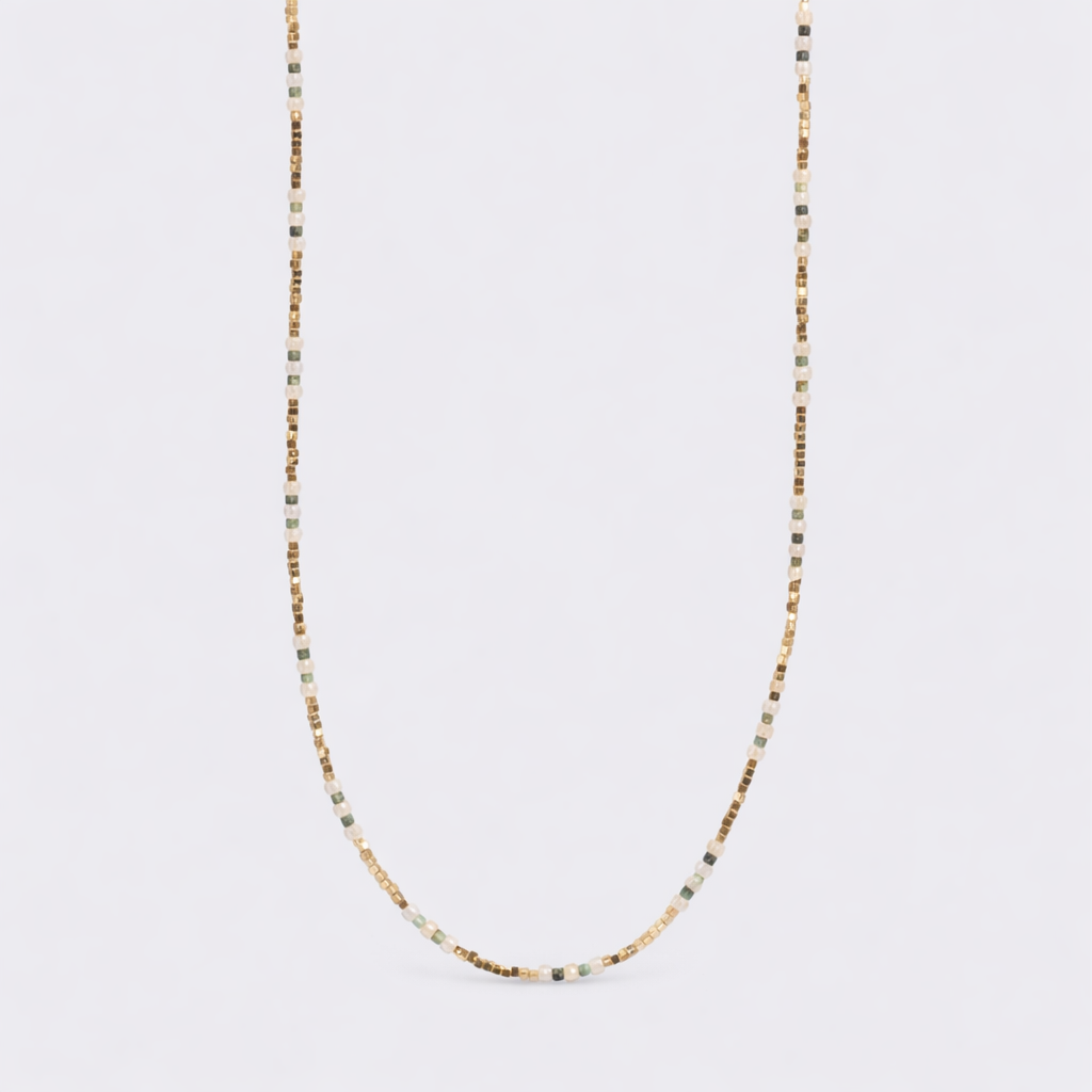 Shiny green miniature necklace from A & C Oslo featuring a small, vibrant green pendant on a delicate chain.