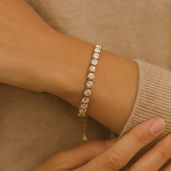 Gold plated tennis bracelet by A & C Oslo featuring a sleek, elegant design with small, sparkling links.