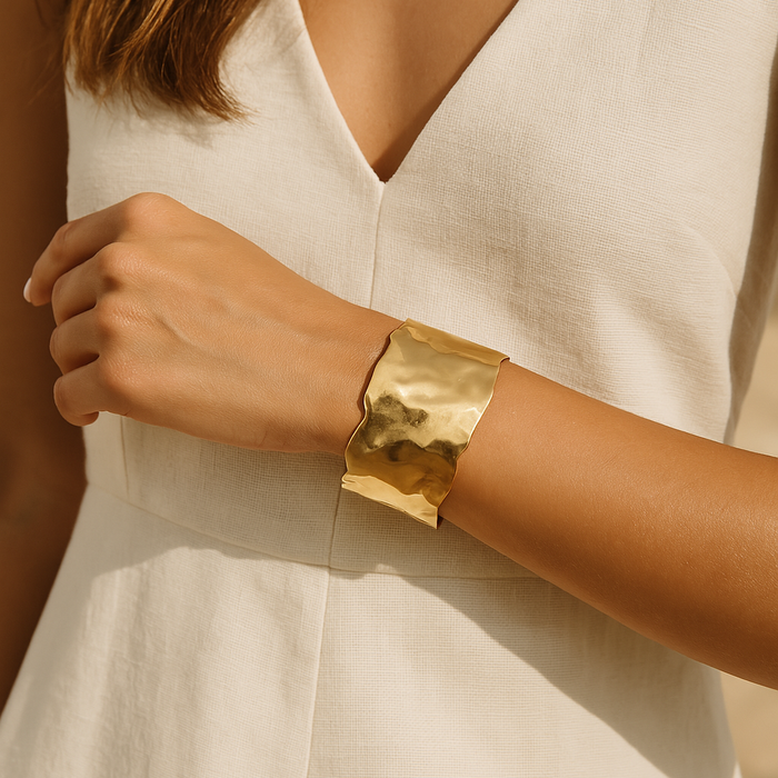 Gold sculpted cuff bracelet by A & C Oslo featuring intricate design and polished finish, crafted for elegant wristwear.