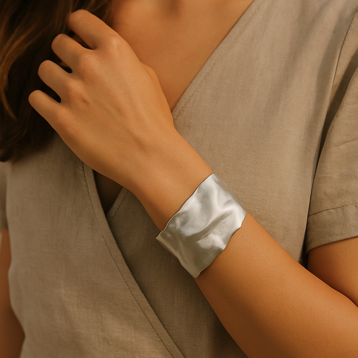 Silver sculpted cuff bracelet by A & C Oslo featuring intricate, modern design with smooth curves and a polished finish.