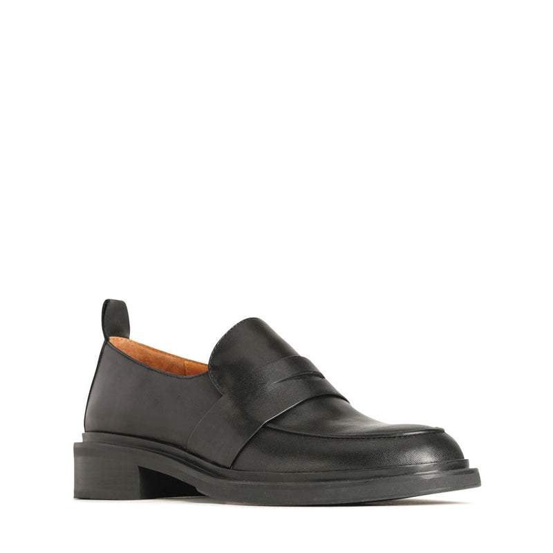 Eos Coia black loafers with sleek design, featuring smooth leather and classic slip-on style, shown from an angled view.