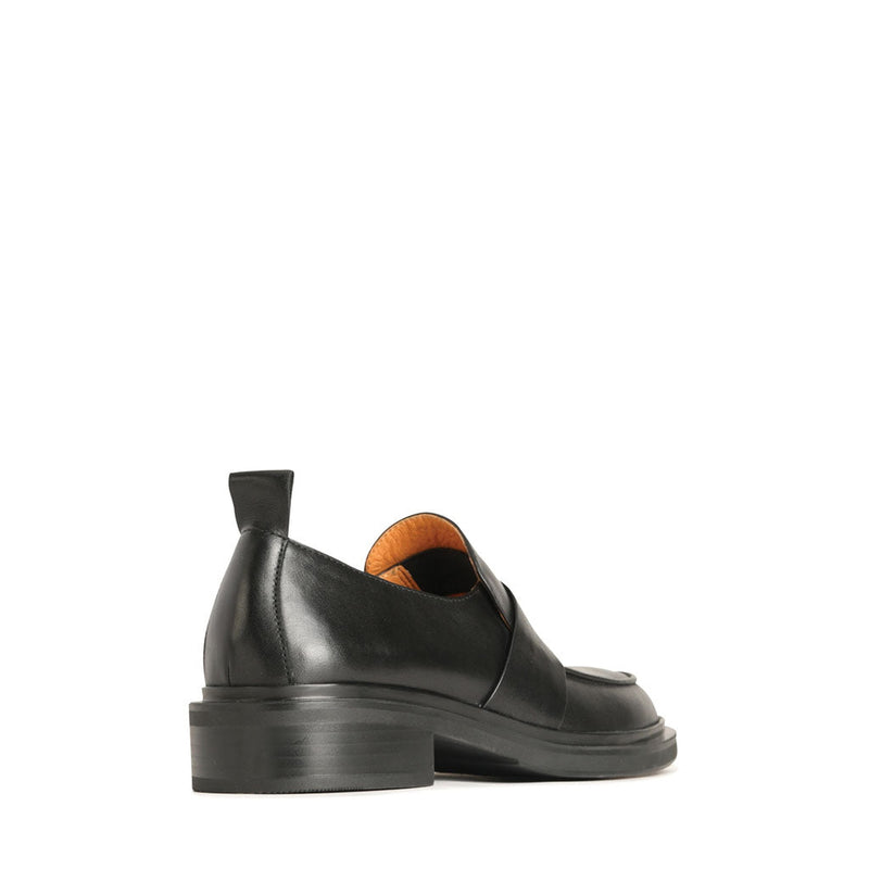 Eos Coia black loafers shown from the back angle, featuring smooth black leather and classic slip-on design.