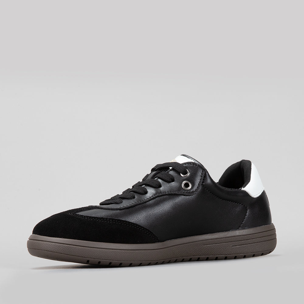 Le Sansa Juno black and white sneakers featuring stylish design and comfortable fit, shown from a side view.