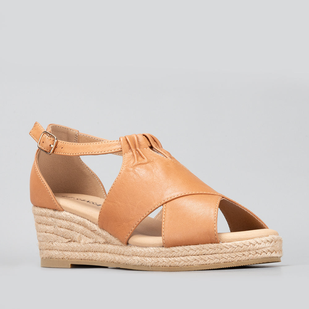 Le Sansa Pernia tan sandals featuring open-toe design and ankle straps, perfect for casual summer wear.