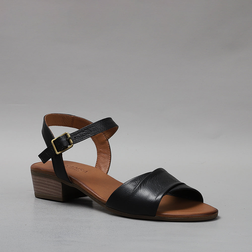 Black Le Sansa Delta sandals with open toes and ankle straps, featuring a sleek and modern design.