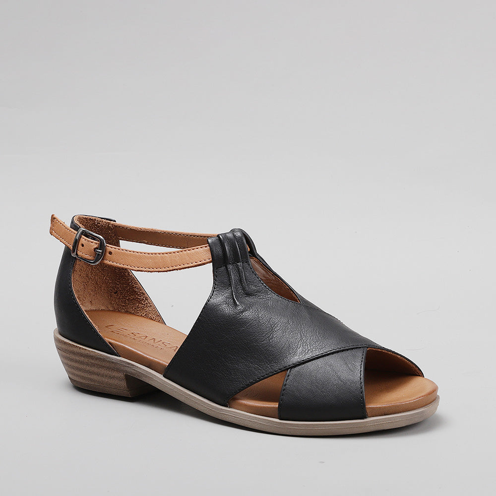 Le Sansa Digby black and tan sandals featuring open toes and ankle straps, displayed on a neutral background.