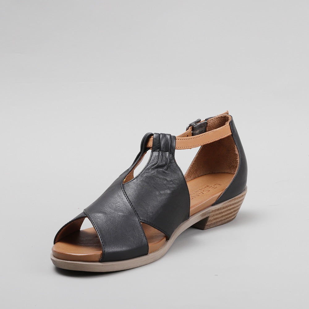 Le Sansa Digby black and tan sandals with southwestern design, featuring open toes and ankle straps for stylish comfort.
