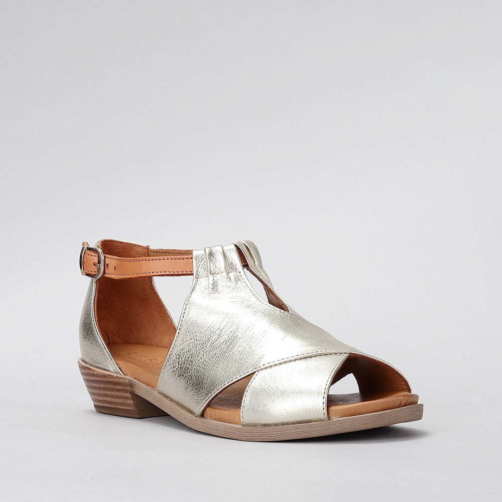 Le Sansa Digby Gold Tan sandals with open toe design and ankle straps, displayed on a neutral background.