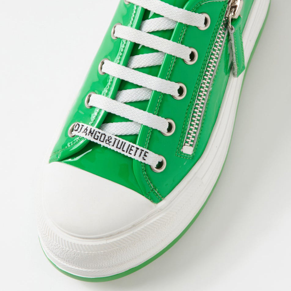 Django & Juliette Giza Emerald Patent sneakers with glossy emerald green finish and white rubber soles.