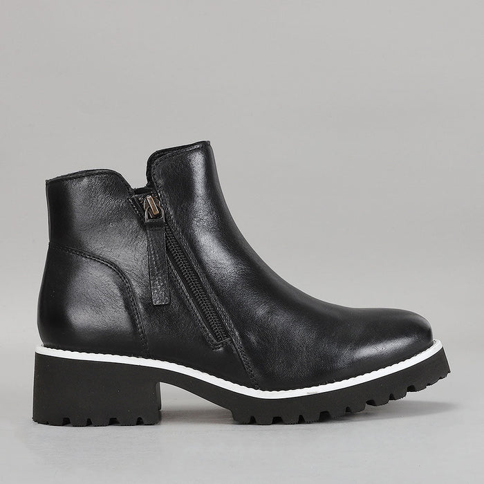 Le Sansa East Black boots showing side view with sleek black leather and stylish design.