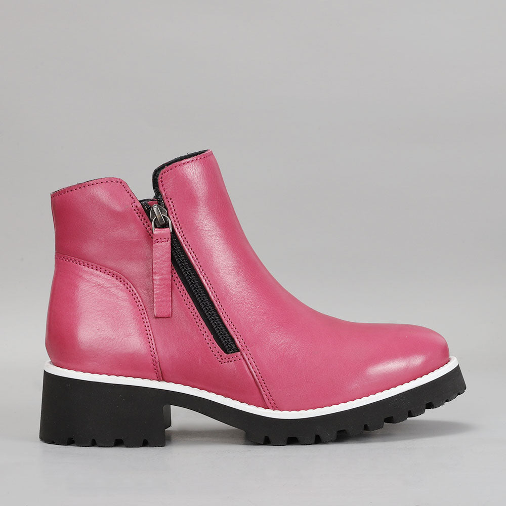 LE SANSA East hot pink boots shown from the side, featuring a stylish design and vibrant color.