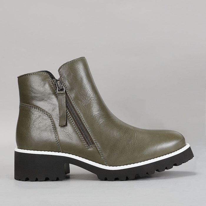 Le Sansa East Olive boots shown from the side, featuring a sleek design and olive green color.