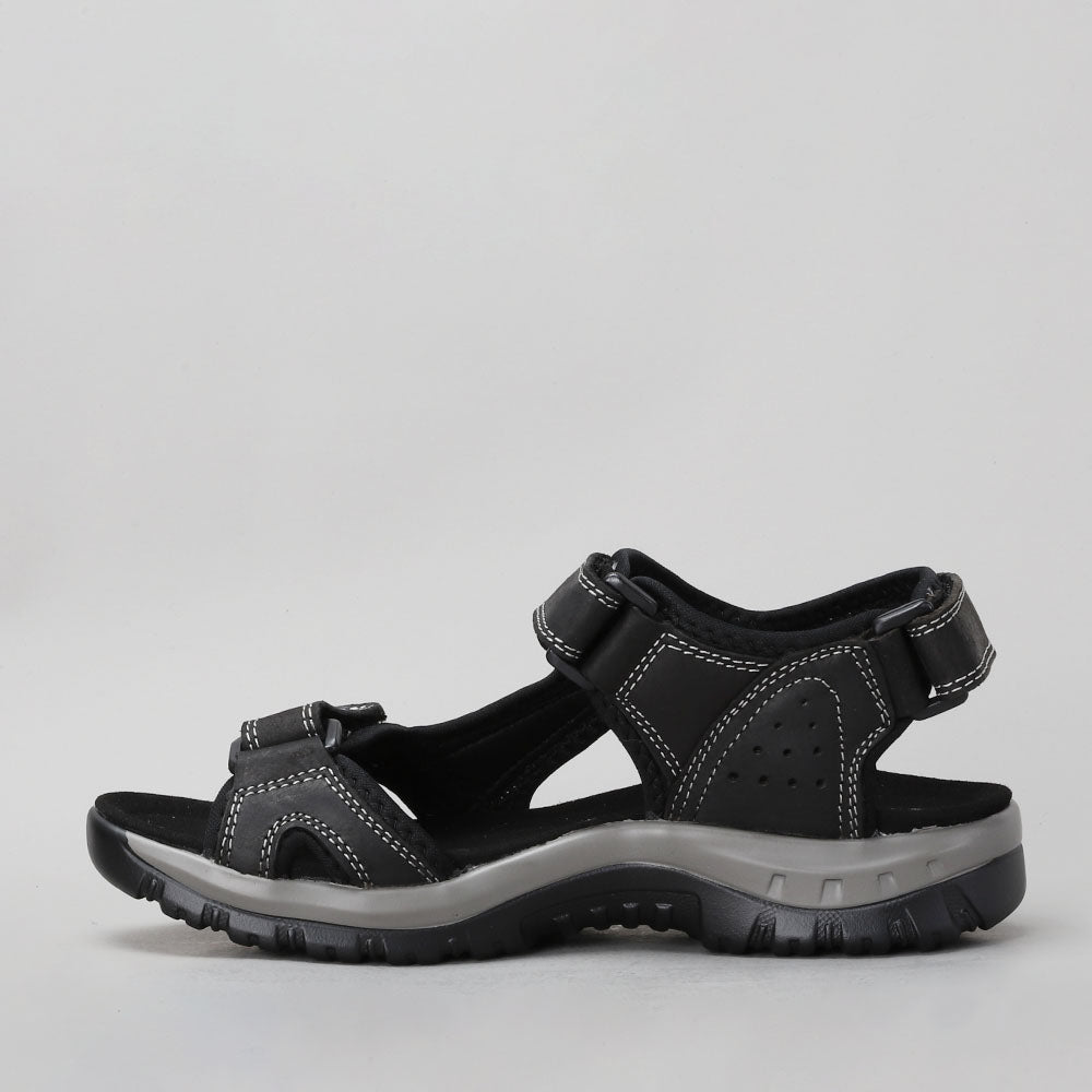 Black CC Resorts EKAM sandals with straps and textured sole, shown on a neutral background.