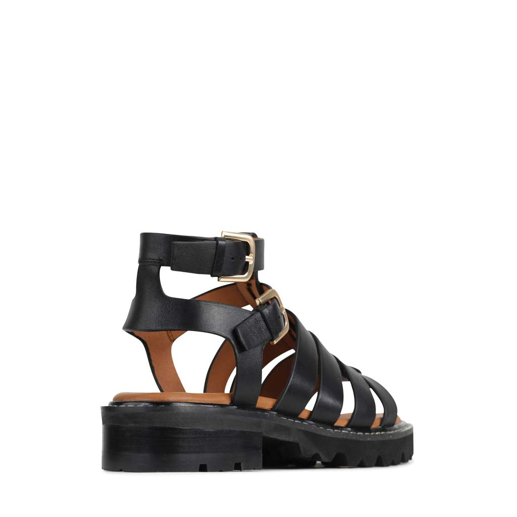 Black EOS Gizelle sandals with open toe design and ankle straps, stylish footwear by Eos.