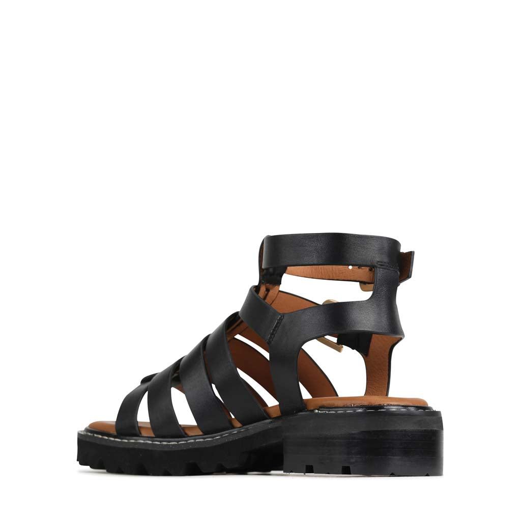 Eos Gizelle Black sandals with open toes and ankle straps, stylish footwear for casual and summer wear.