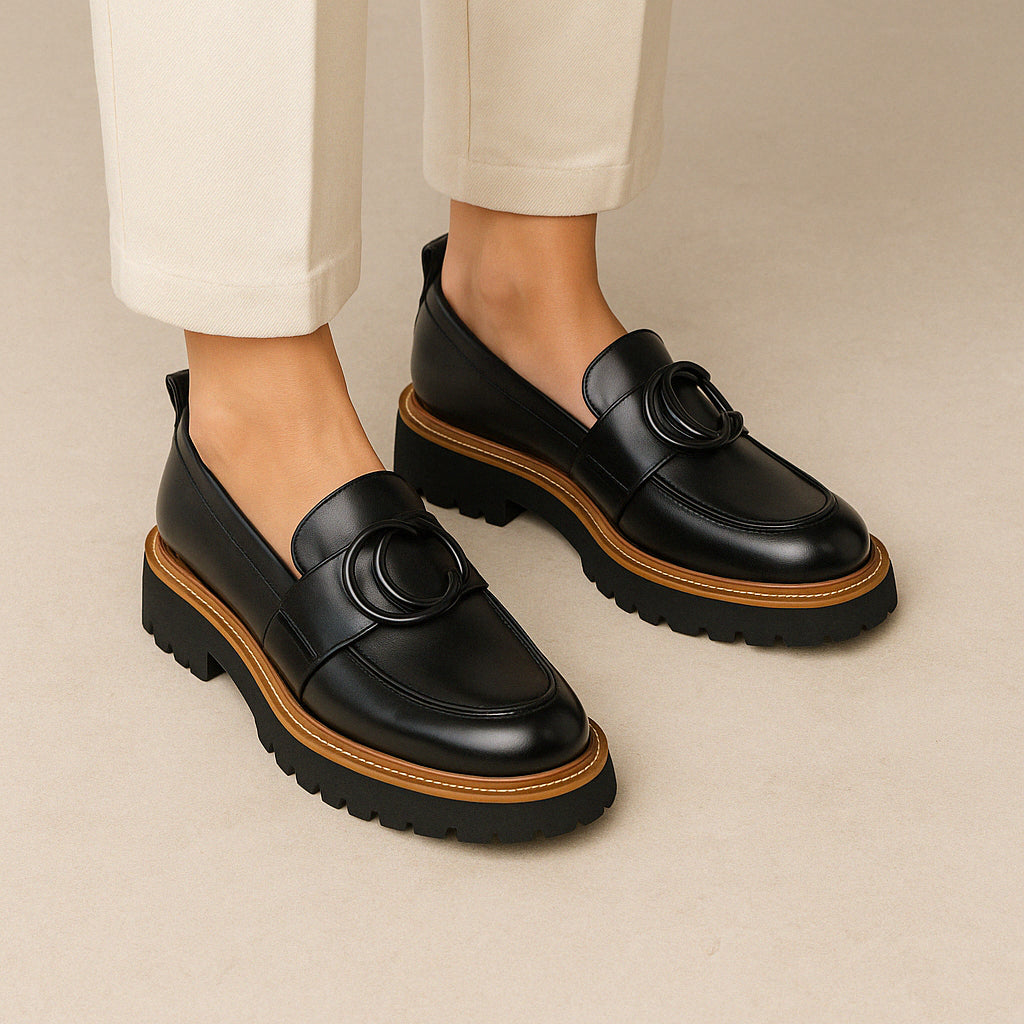 Eos Abbi black loafers shown from the back, stylish slip-on footwear with sleek design and low heel for casual or formal wear.