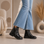 Black EOS Theona boots with lace-up front and chunky heel, stylish footwear for casual or chic occasions.