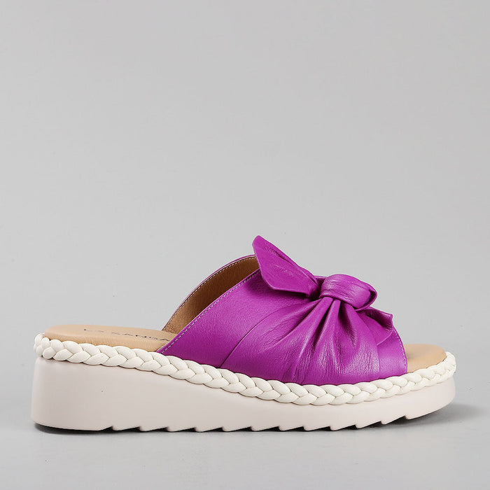 Le Sansa Eudore purple slip-ons showing a side view with smooth fabric and comfortable design.