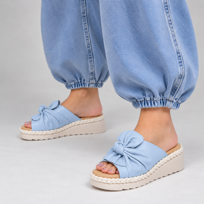 Le Sansa Eudore baby blue slip-on shoes for infants, featuring soft fabric and comfortable design.