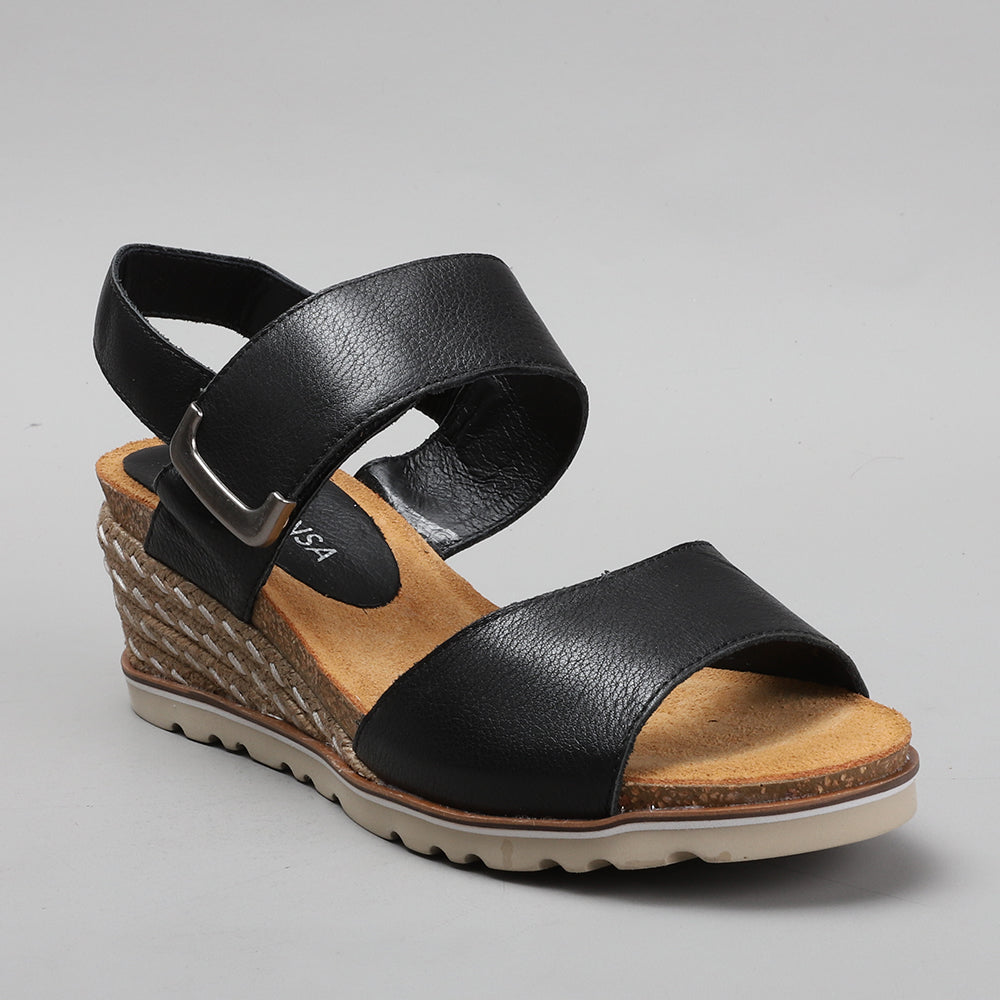 Le Sansa Evita Black sandals with open toe design and ankle strap, featuring sleek black leather for stylish summer wear.