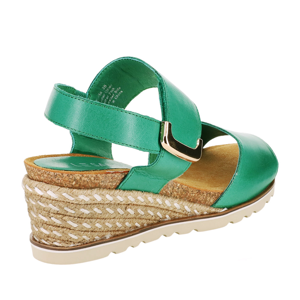 Le Sansa Evita Pine sandals featuring tan leather straps and a comfortable flat sole, perfect for casual summer wear.