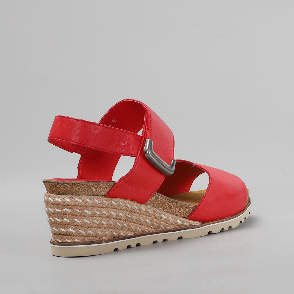 Le Sansa Evita red sandals with open toes and ankle straps, featuring a stylish and comfortable design.