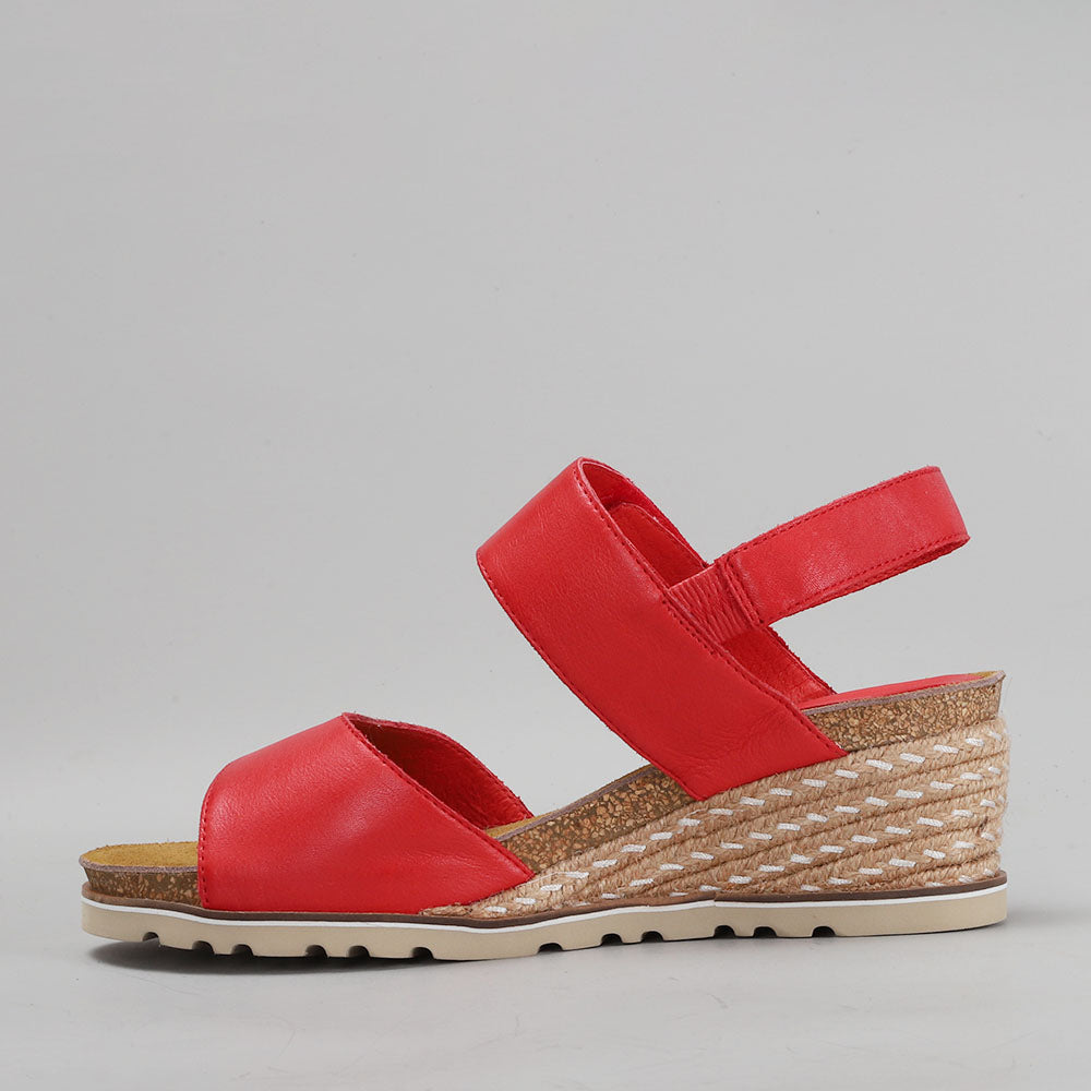 Le Sansa Evita Red sandals featuring open toes and ankle straps, displayed on a neutral background.