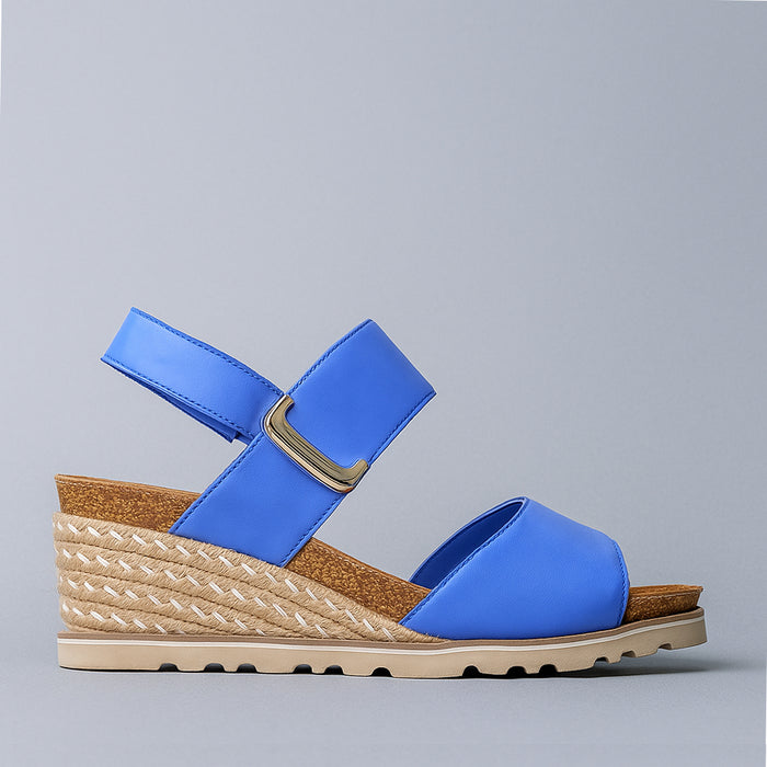 Le Sansa Evita Royal Blue sandals featuring stylish straps and comfortable soles, perfect for casual summer wear.