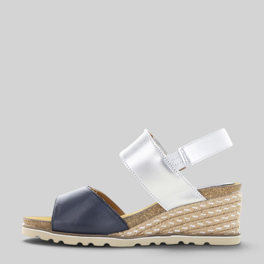 Le Sansa Evita navy silver sandals with ankle straps and open toe design, stylish footwear for warm weather.