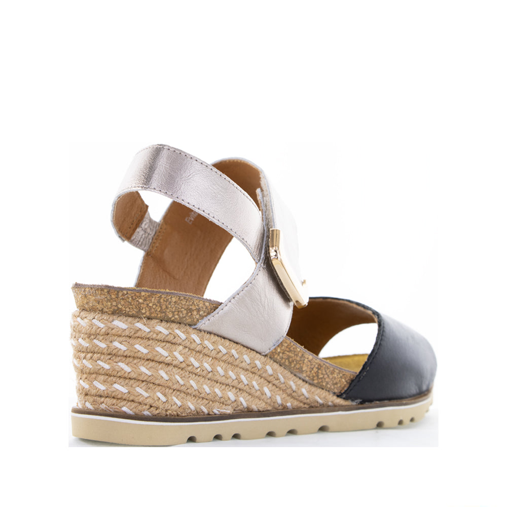 Le Sansa Evita Black Champagne sandals featuring sleek black straps and elegant design on a neutral background.