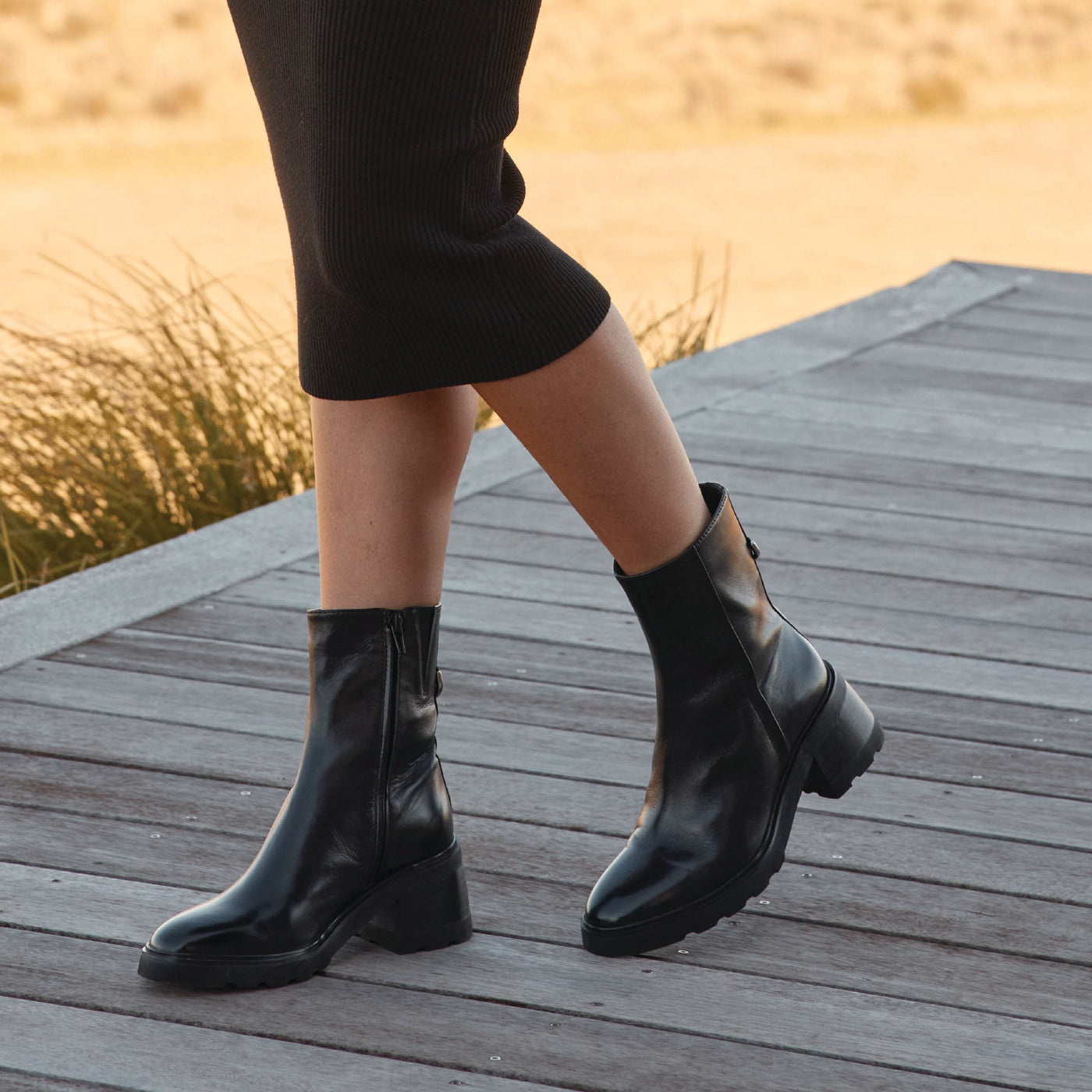 Black EOS Finley boots with a sleek design, featuring smooth leather and low block heels, perfect for casual or formal wear.