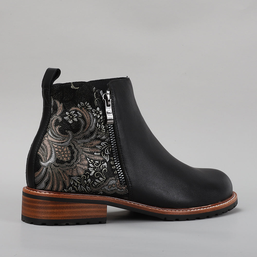 Black print leather boots by Le Sansa featuring stylish fig design and ankle-high cut, perfect for casual or dressy outfits.